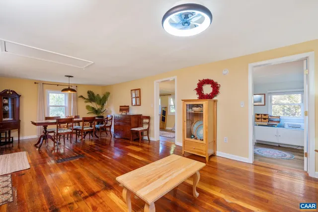 a living room with furniture a window and wooden floor