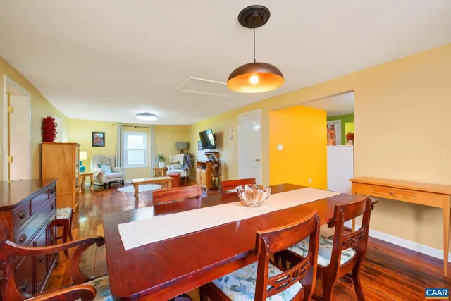 a view of a dining room with furniture wooden floor and chandelier