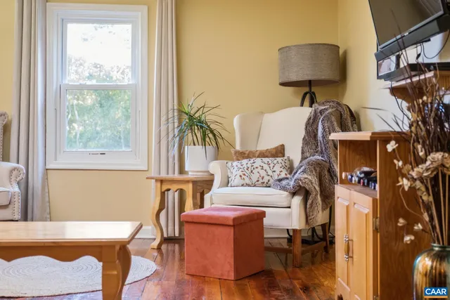 a living room with furniture a window and a lamp