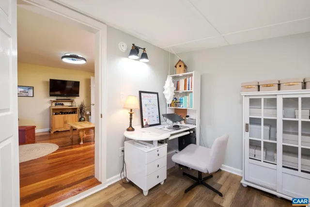 a view of a workspace with furniture and a flat screen tv