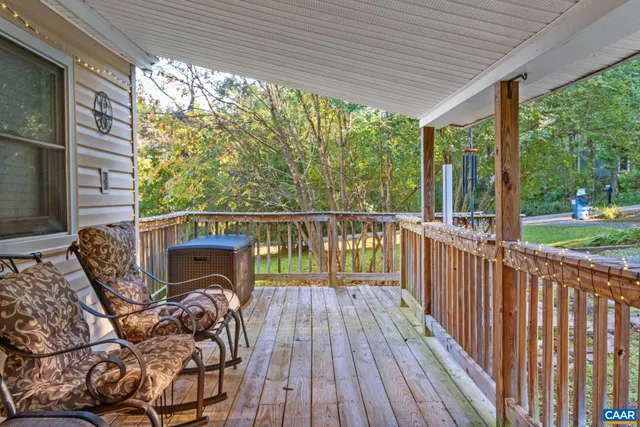 a view of balcony with wooden floor and outdoor seating