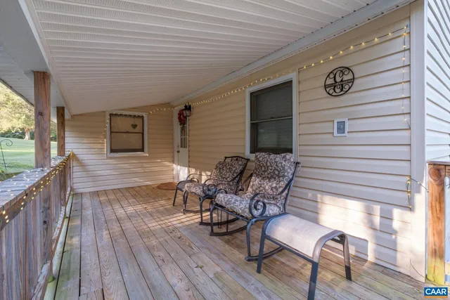a outdoor view with a sitting space and large trees