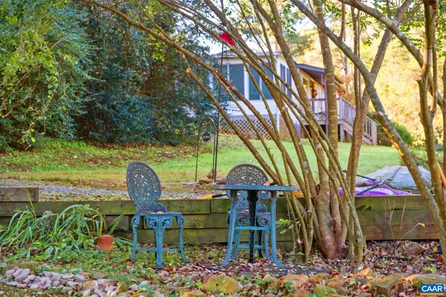 a view of a chair and table in the garden