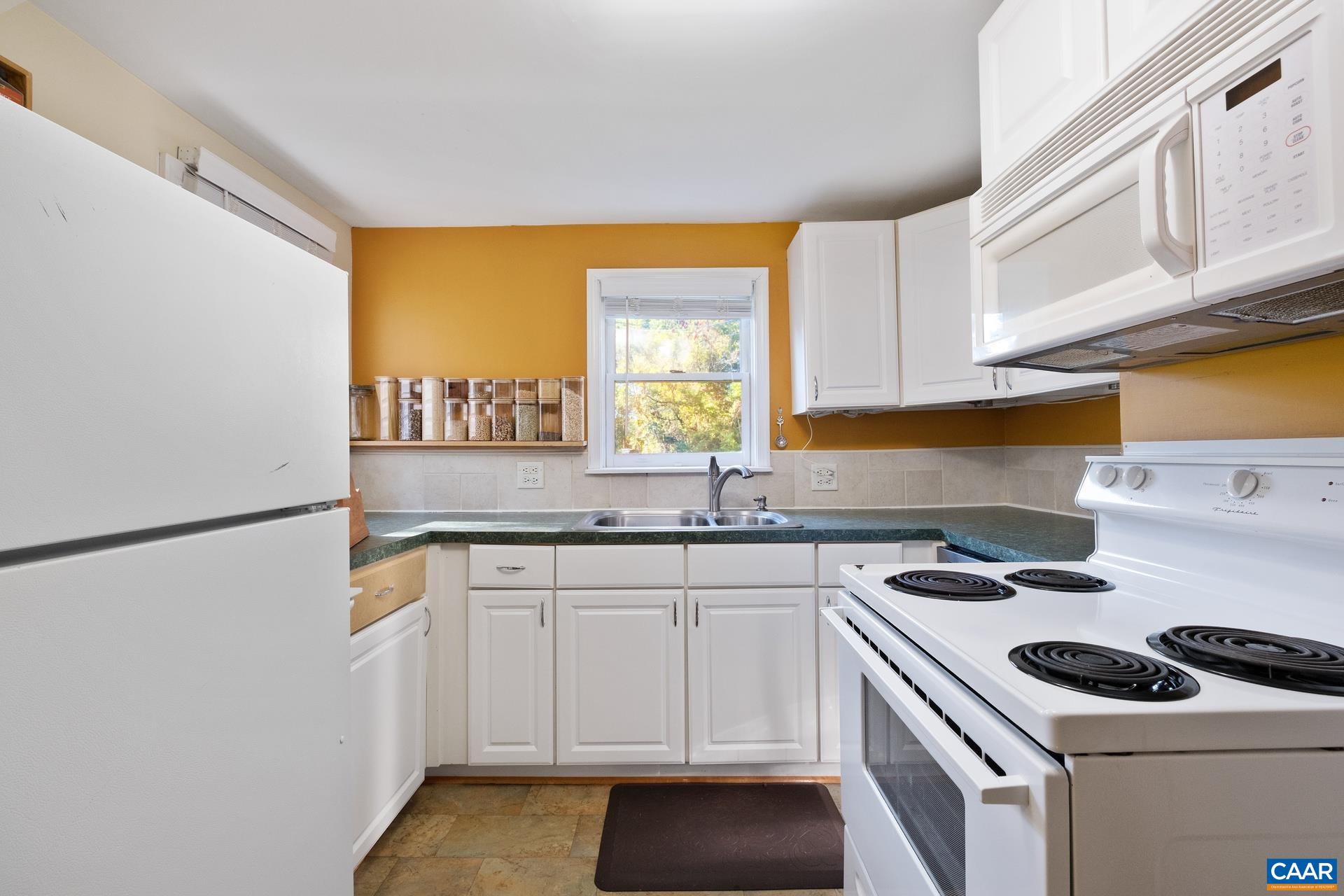 4601 Loving Road North Garden, VA 22959 - Photo 9 of 33 a kitchen with a sink a stove cabinets and white appliances