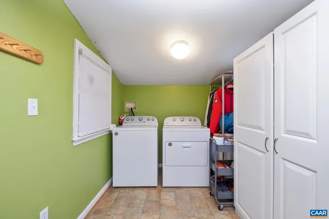 a view of storage and utility room with closet and washing machine