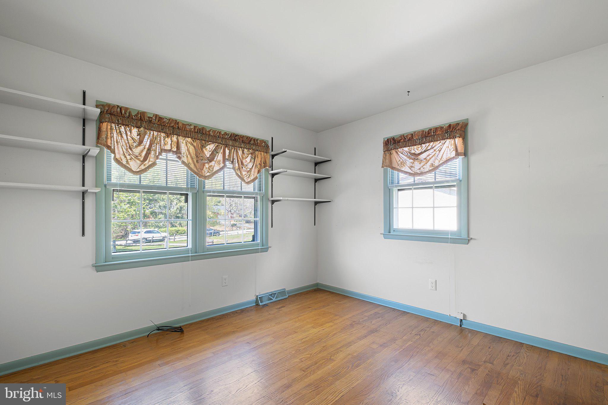 903 Clydesdale Drive Bear, DE 19701 - Photo 11 of 20 an empty room with wooden floor and windows