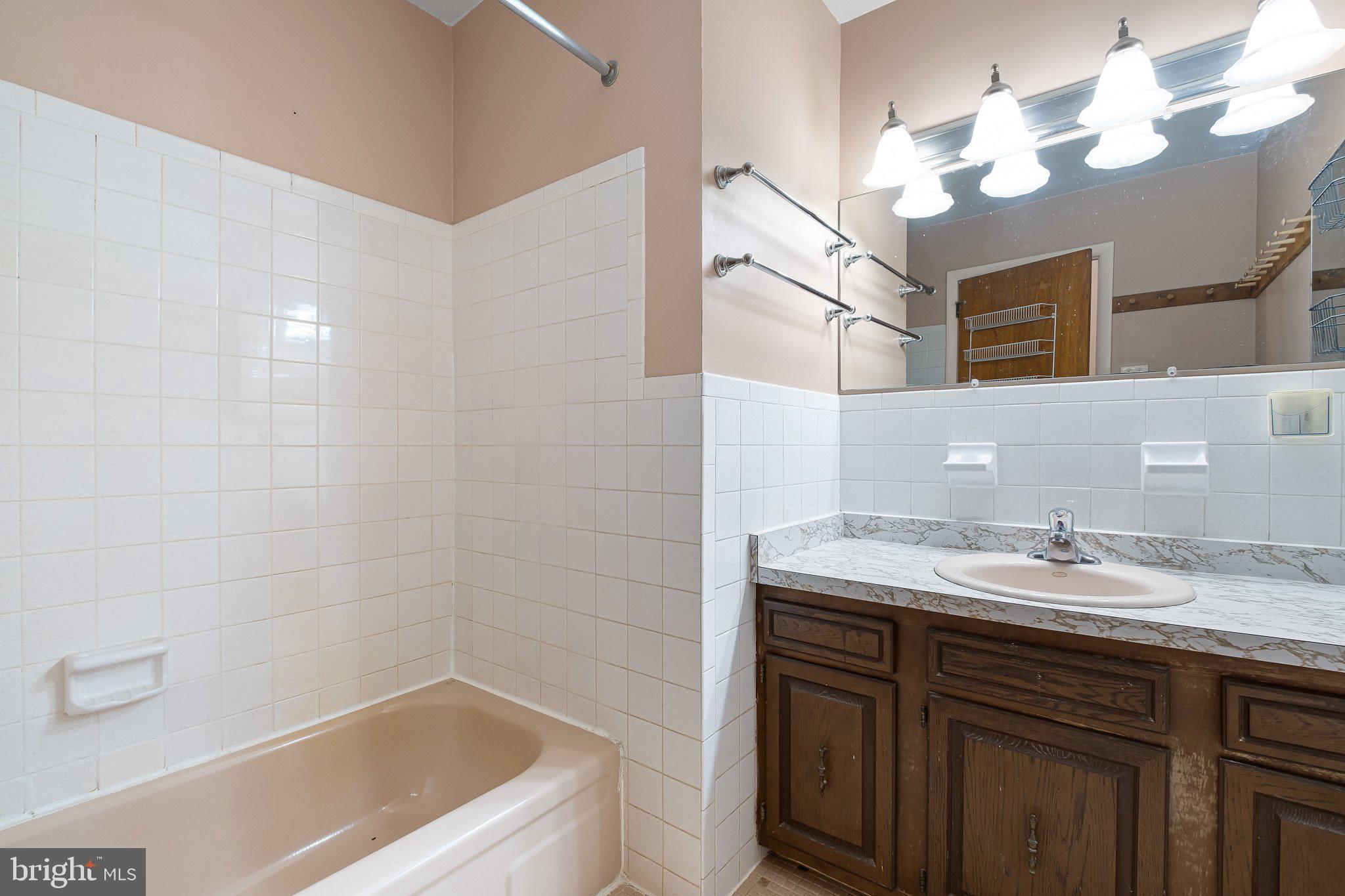 903 Clydesdale Drive Bear, DE 19701 - Photo 13 of 20 a bathroom with a granite countertop sink a mirror and a bathtub