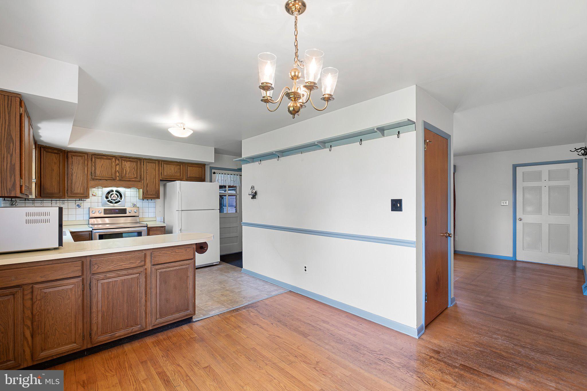 903 Clydesdale Drive Bear, DE 19701 - Photo 20 of 20 a kitchen with kitchen island wooden floors appliances and cabinets