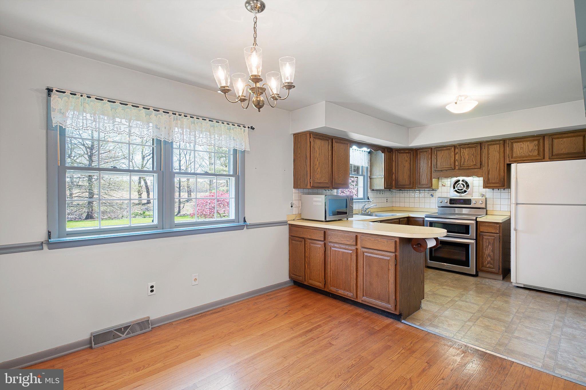 903 Clydesdale Drive Bear, DE 19701 - Photo 2 of 20 a kitchen with stainless steel appliances granite countertop a stove top oven a refrigerator a sink dishwasher with a dining table and chairs