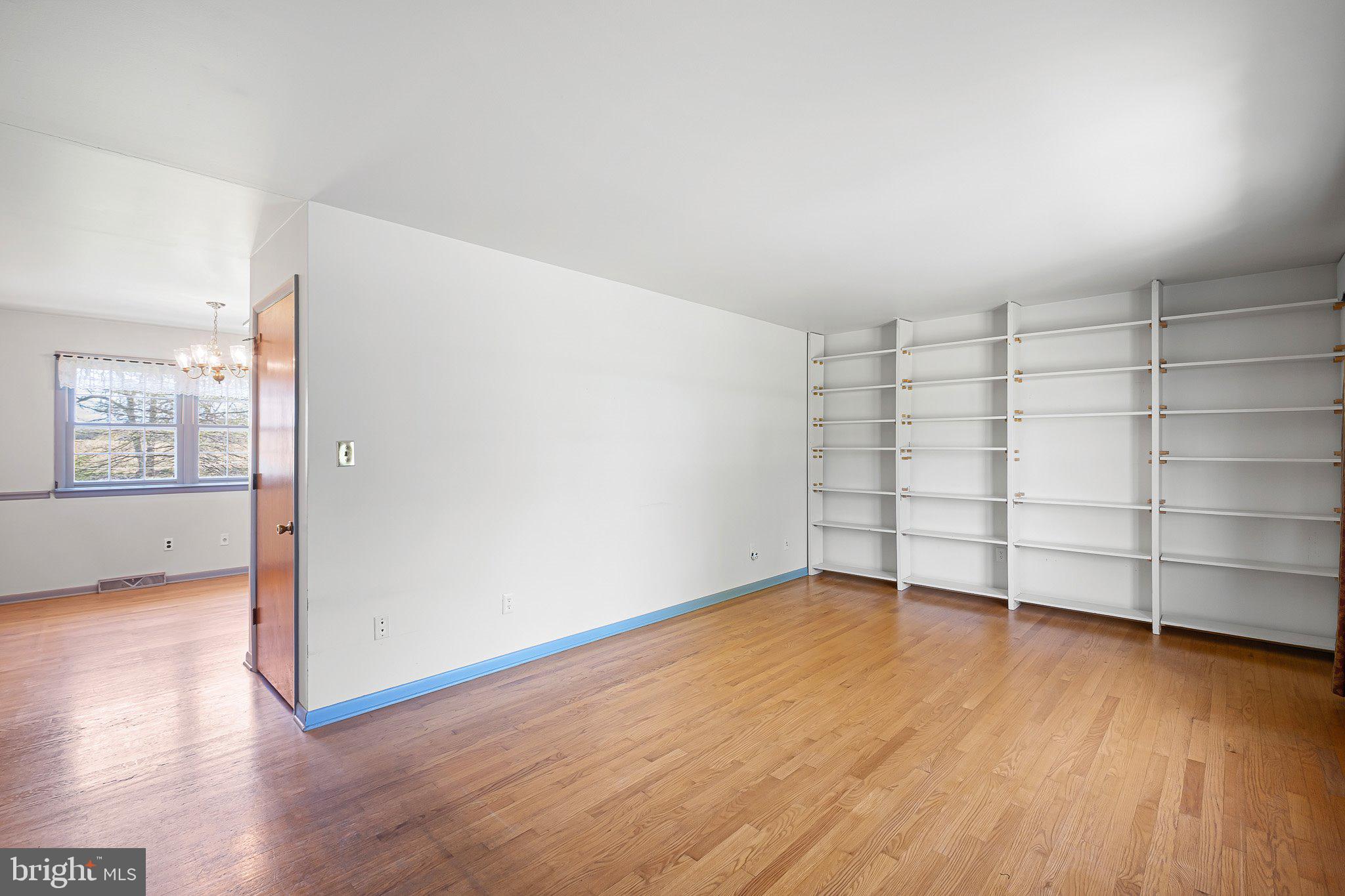 903 Clydesdale Drive Bear, DE 19701 - Photo 6 of 20 an empty room with wooden floor and cabinet