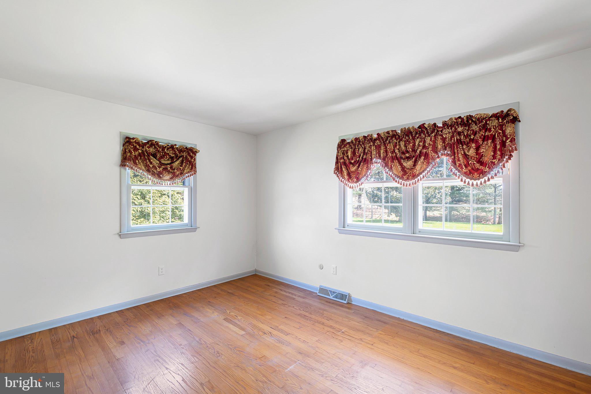 903 Clydesdale Drive Bear, DE 19701 - Photo 8 of 20 a view of an empty room with a window and wooden floor