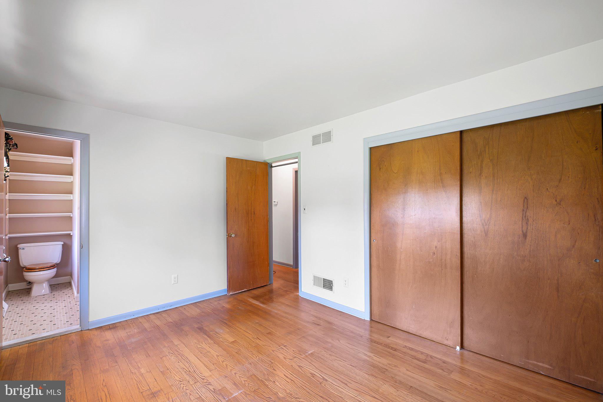 903 Clydesdale Drive Bear, DE 19701 - Photo 9 of 20 a view of empty room with wooden floor and fan