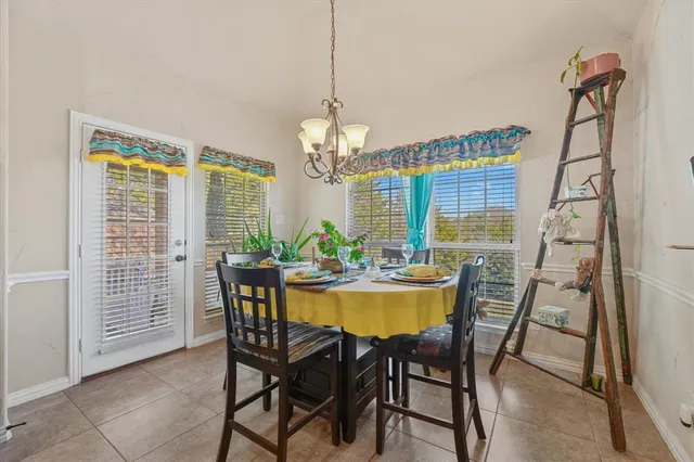 a view of a dining room with furniture and a chandelier