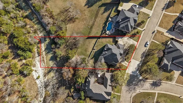 a view of a yard with trees in the background