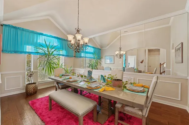 a view of a dining room with furniture and a chandelier