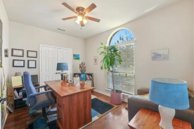 a workspace with furniture and a large window