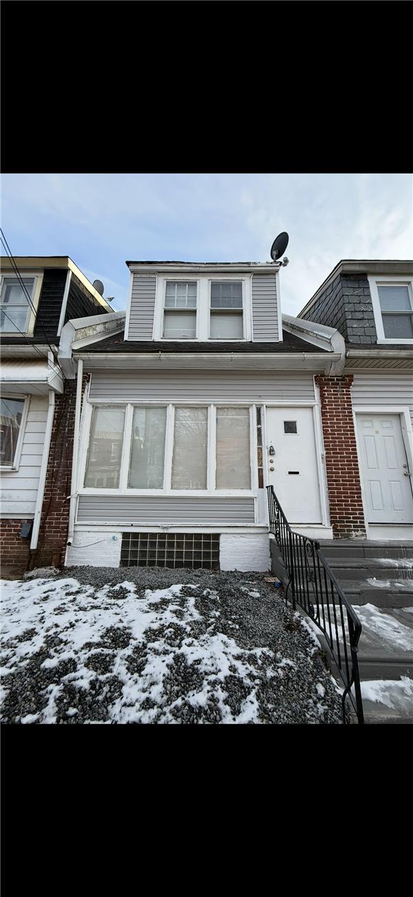 5107 Cottage Street, Unit 1 Philadelphia, PA 19124 - Photo 1 of 7 A classic brick and siding row home facade, poised for a personalized touch.