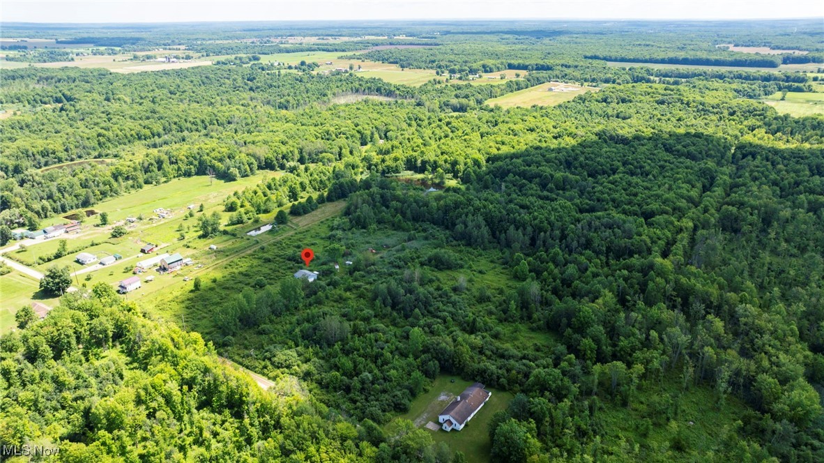 876 Clay Road Jefferson, OH 44047 - Photo 8 of 18 Aerial view of property and surrounding area featuring a forest