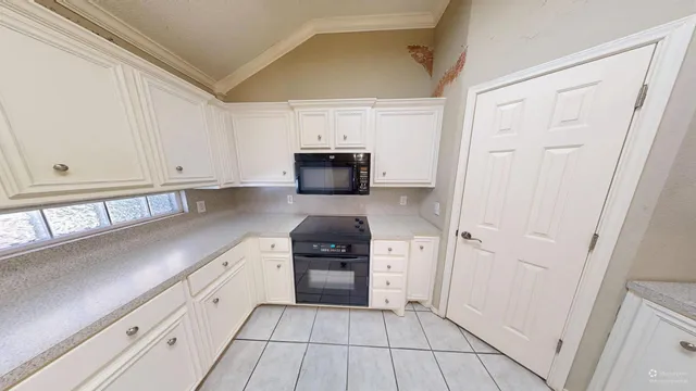 a view of a kitchen with a sink and dishwasher a refrigerator with wooden floor