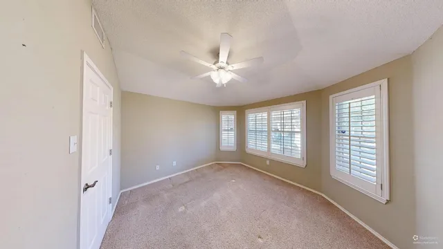 a view of a livingroom with a ceiling fan and window