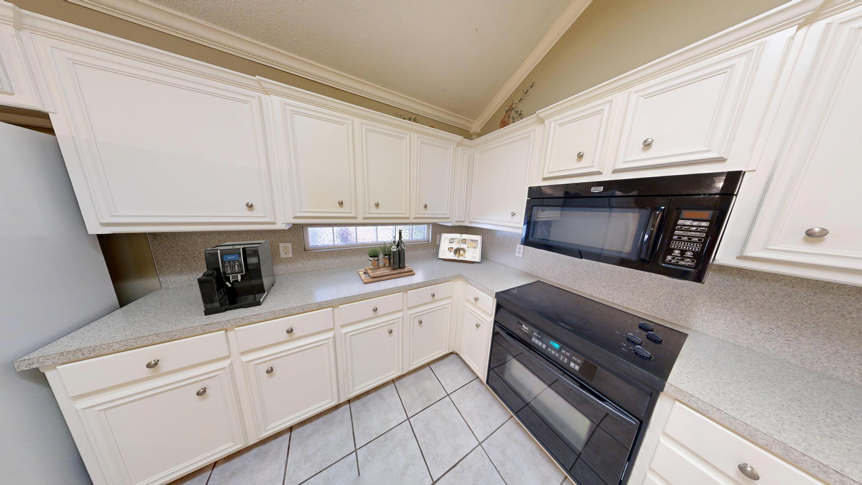 3511 104th Street Lubbock, TX 79423 - Photo 9 of 25 a kitchen with white cabinets and appliances