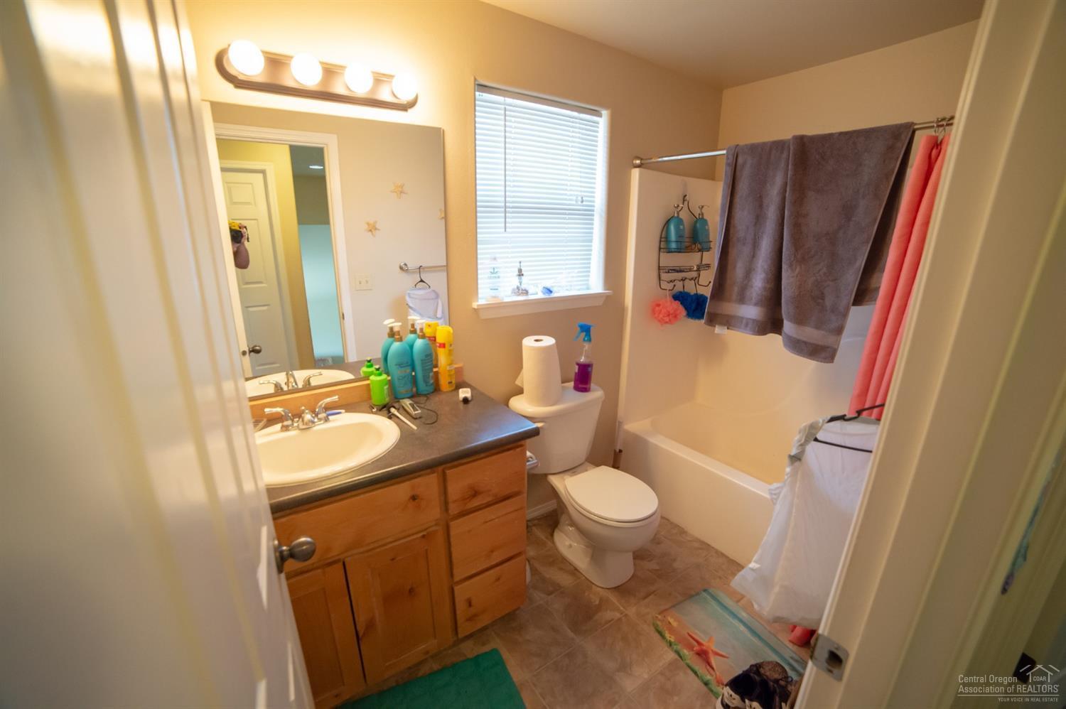 63287 Vogt Road Bend, OR 97701 - Photo 8 of 16 a bathroom with a sink toilet a mirror and vanity