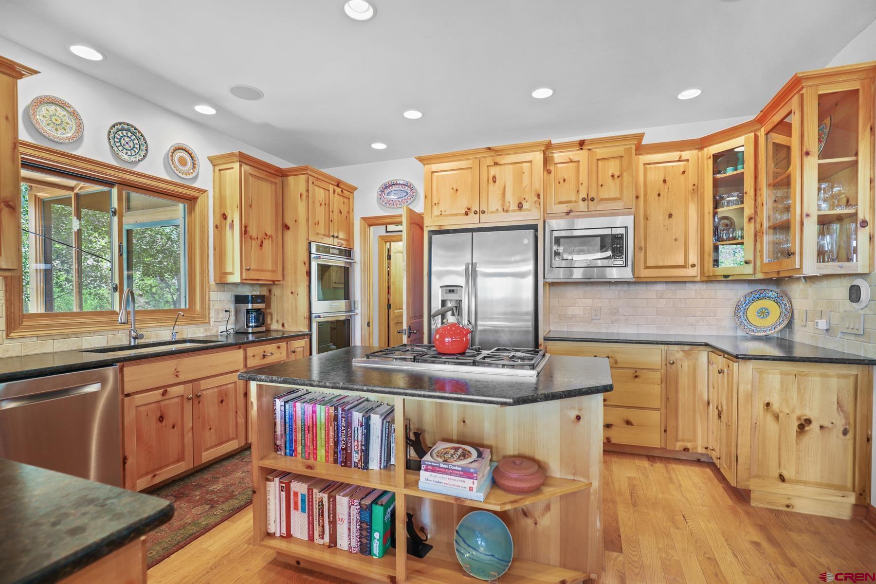 756 Horse Gulch Loop Durango, CO 81301 - Photo 11 of 35 a kitchen with stainless steel appliances granite countertop a stove and a sink