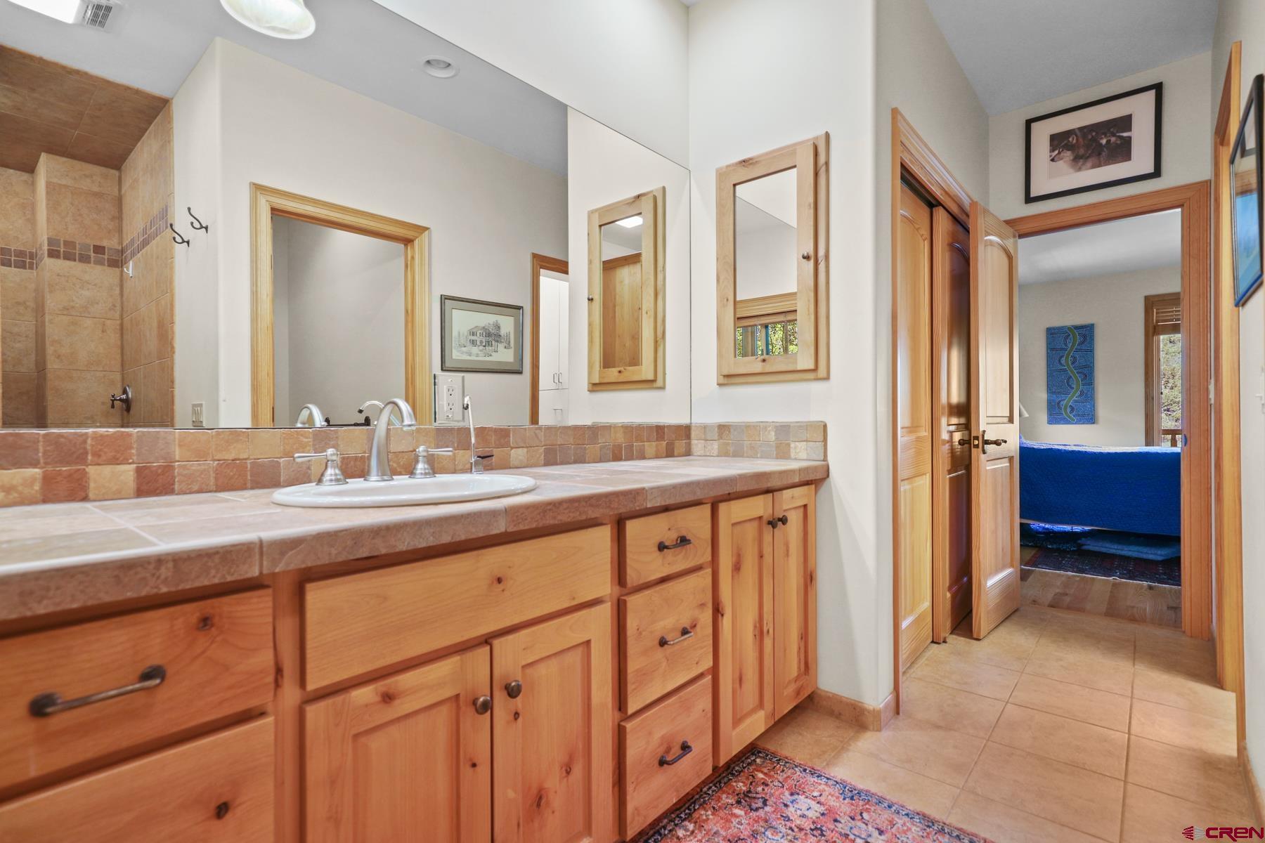 756 Horse Gulch Loop Durango, CO 81301 - Photo 13 of 35 a spacious bathroom with double sink and a mirror
