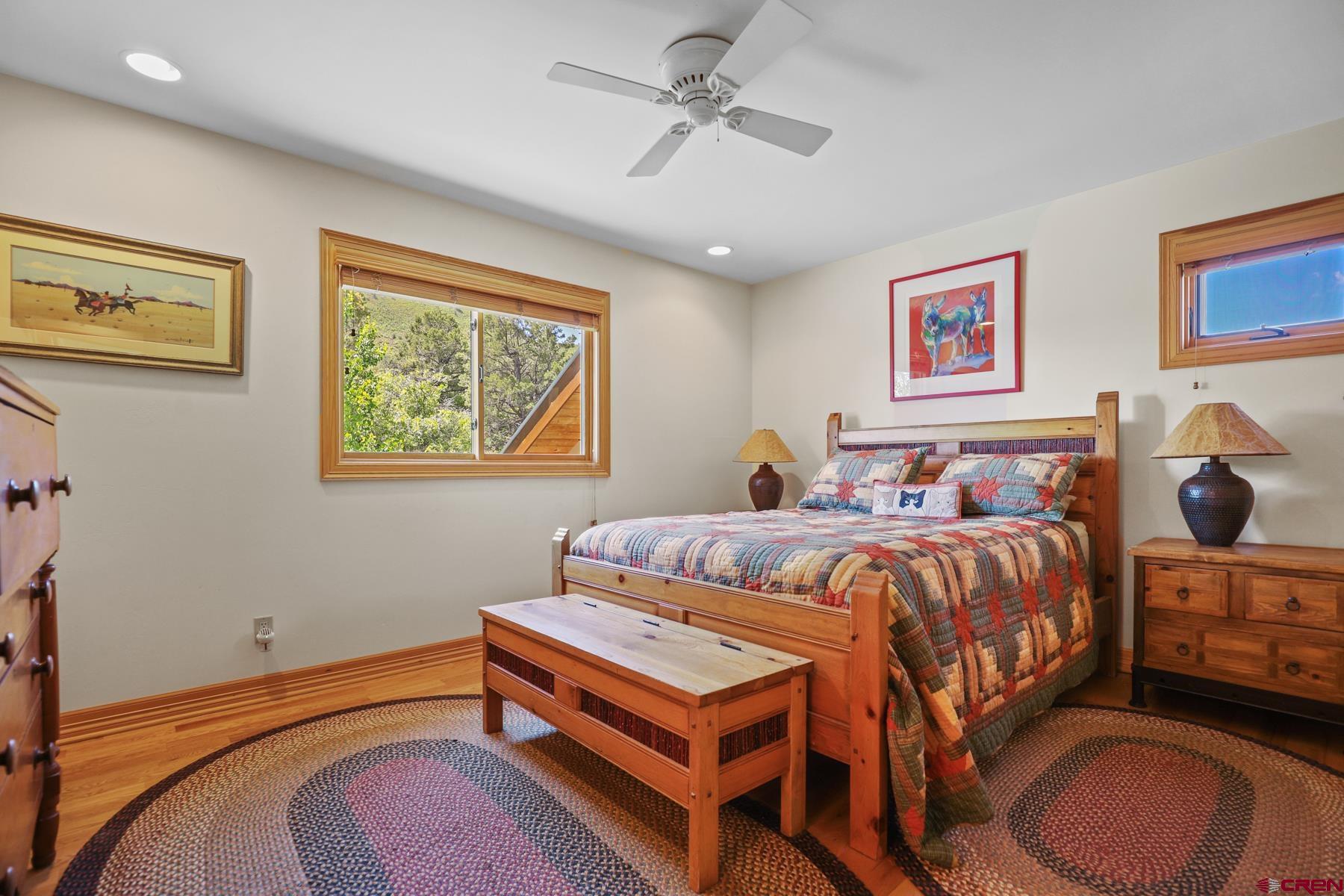 756 Horse Gulch Loop Durango, CO 81301 - Photo 15 of 35 a bedroom with a bed and wooden floor