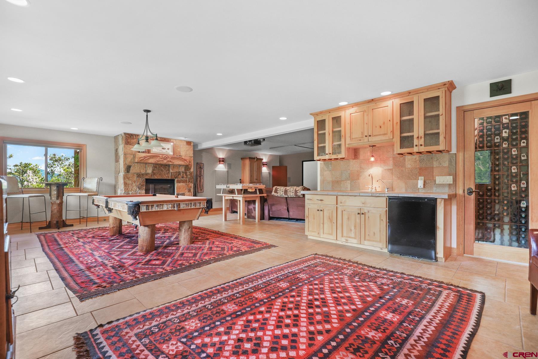 756 Horse Gulch Loop Durango, CO 81301 - Photo 18 of 35 a living room with furniture a rug and a fireplace