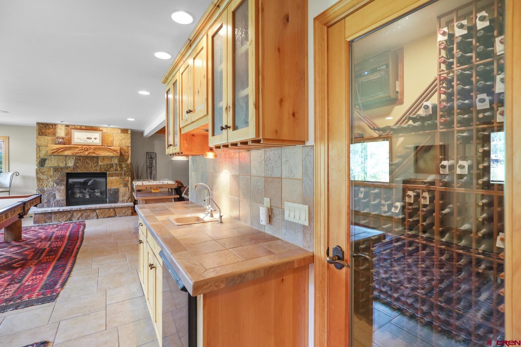 756 Horse Gulch Loop Durango, CO 81301 - Photo 19 of 35 a kitchen with a sink a stove and a dining table