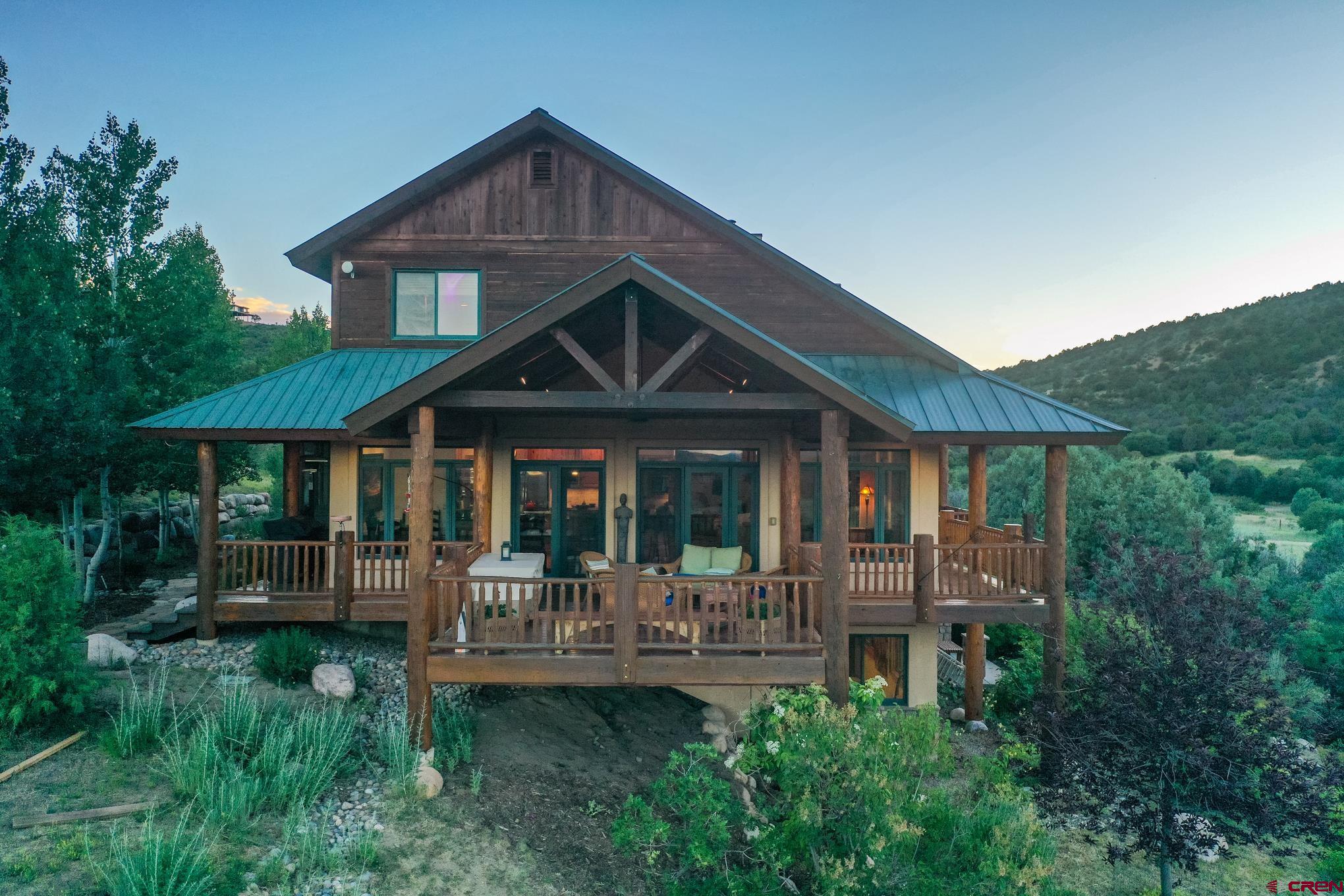 756 Horse Gulch Loop Durango, CO 81301 - Photo 2 of 35 a front view of a house with a yard table and chairs