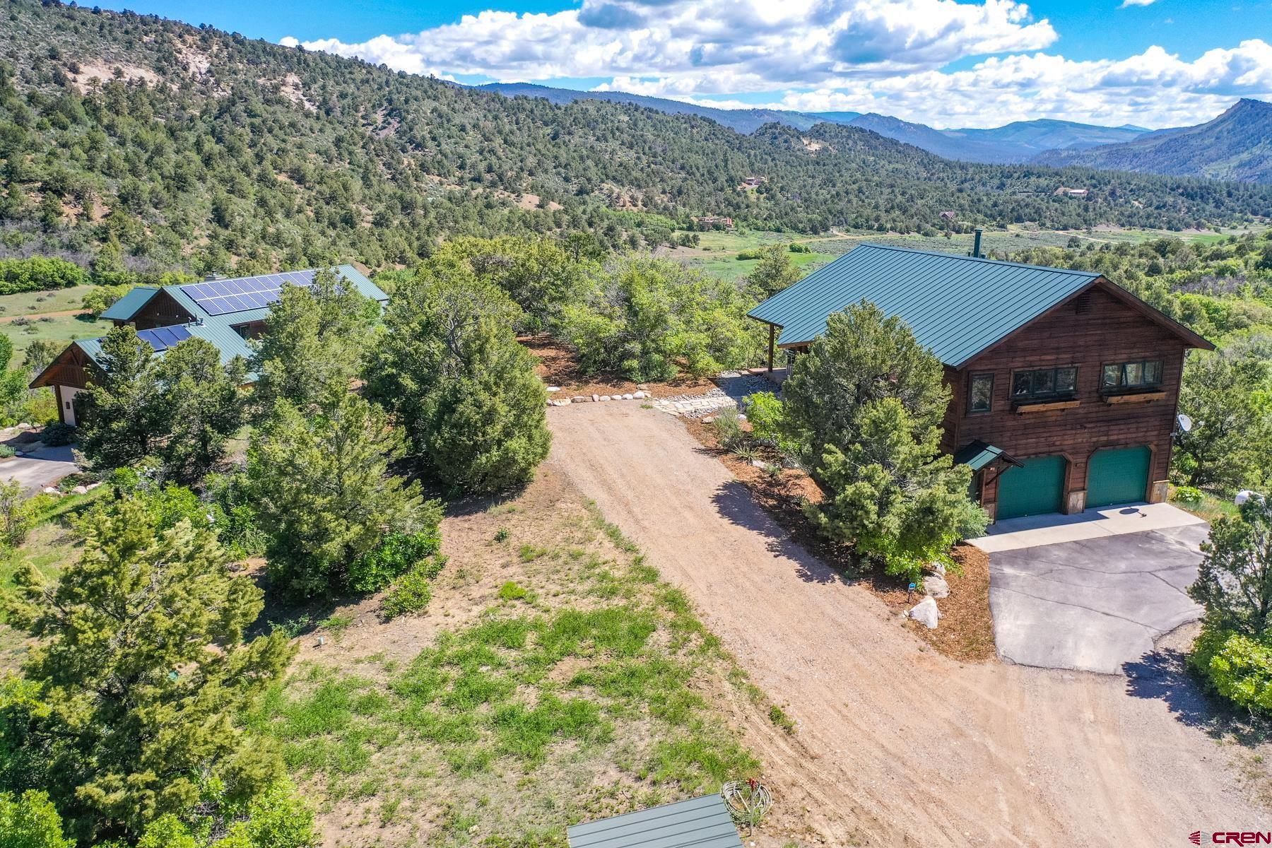 756 Horse Gulch Loop Durango, CO 81301 - Photo 25 of 35 an aerial view of a house with a yard and lake view