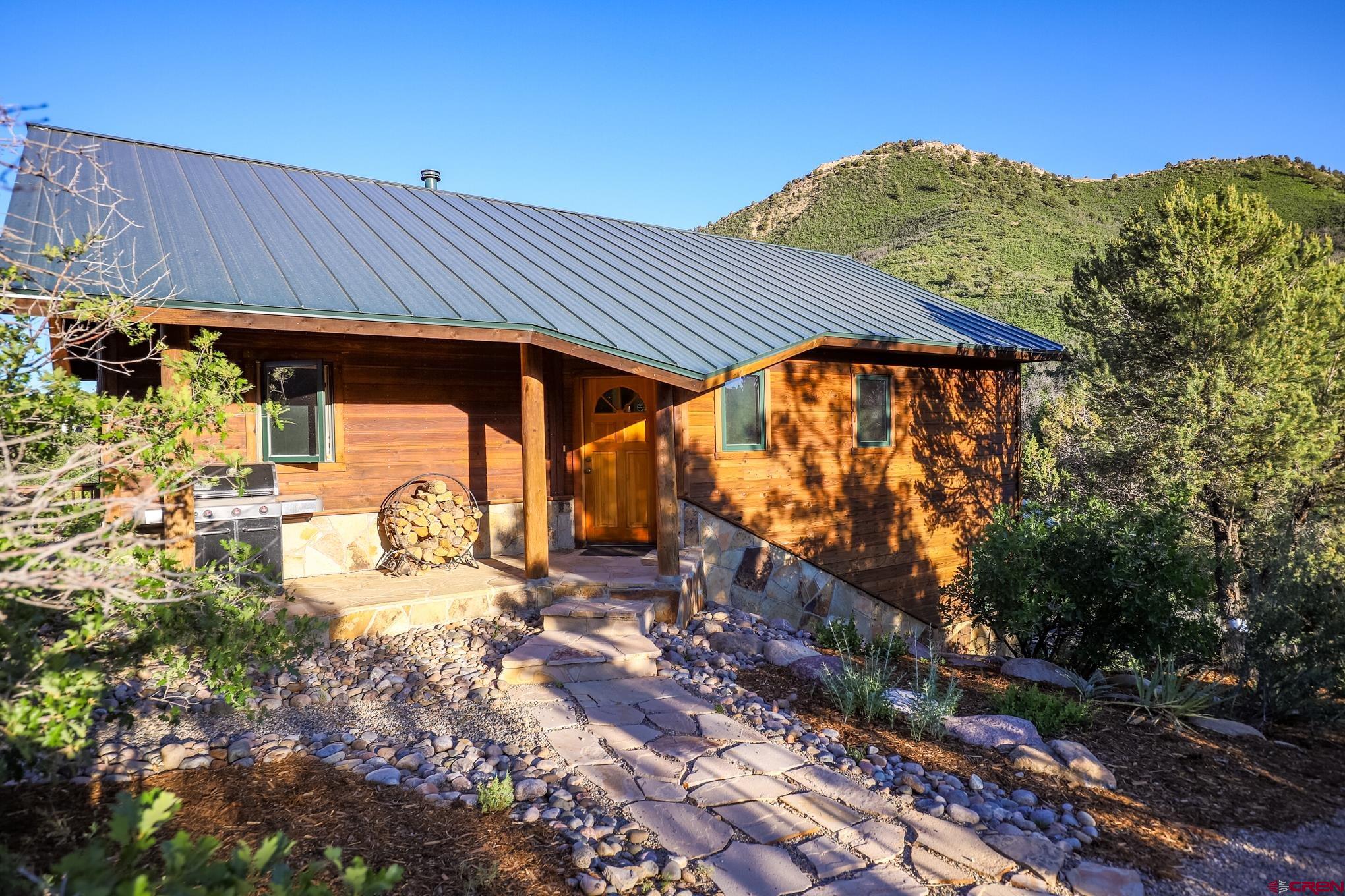 756 Horse Gulch Loop Durango, CO 81301 - Photo 26 of 35 a view of a patio with table and chairs under an umbrella