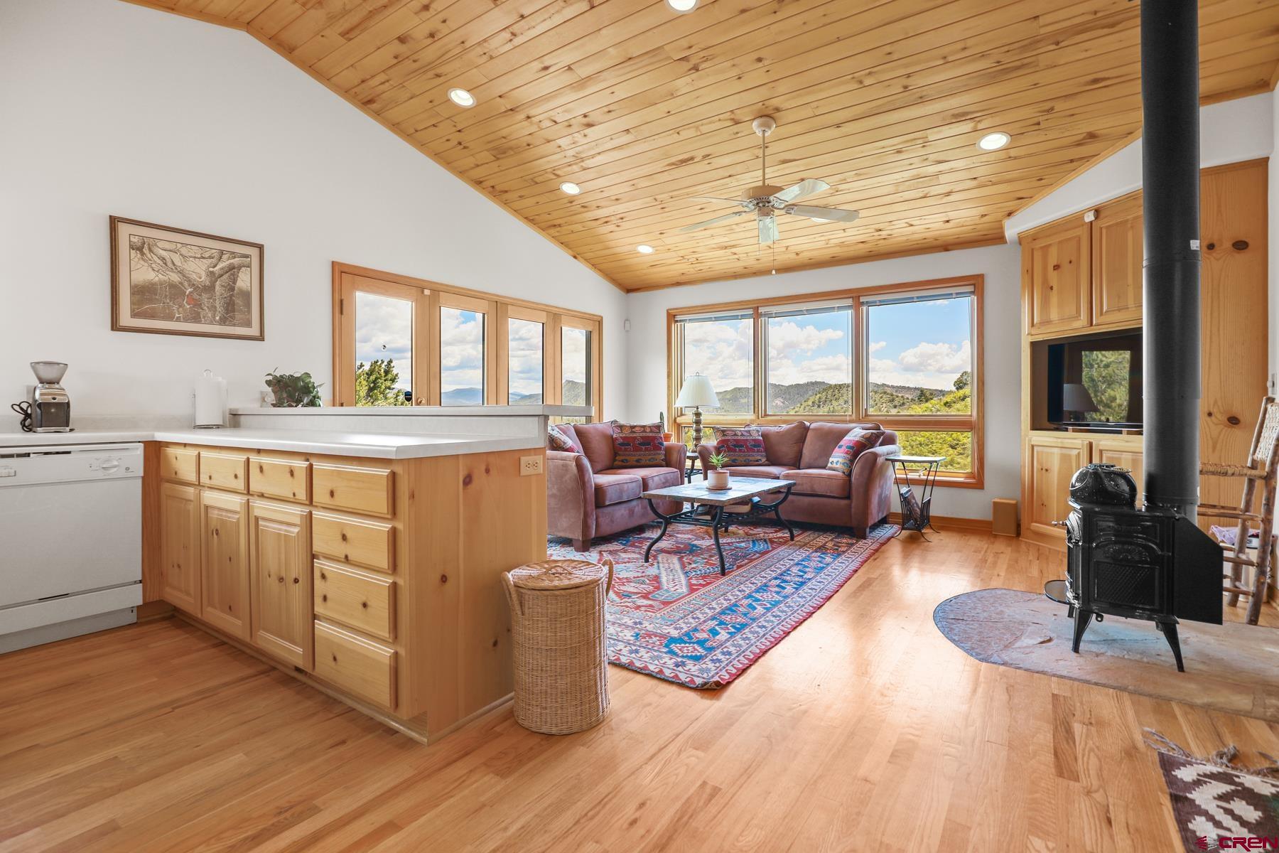 756 Horse Gulch Loop Durango, CO 81301 - Photo 27 of 35 a living room with furniture a flat screen tv and a large window
