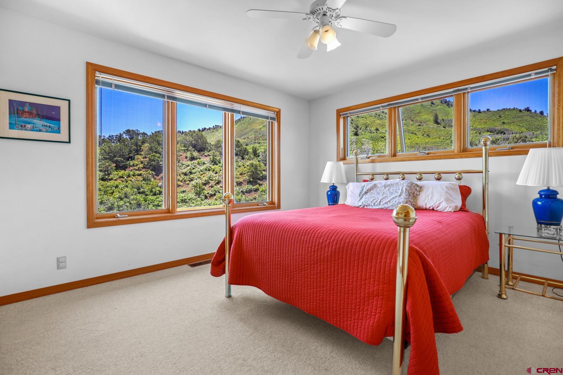 756 Horse Gulch Loop Durango, CO 81301 - Photo 31 of 35 a bed room with a bed and a large window
