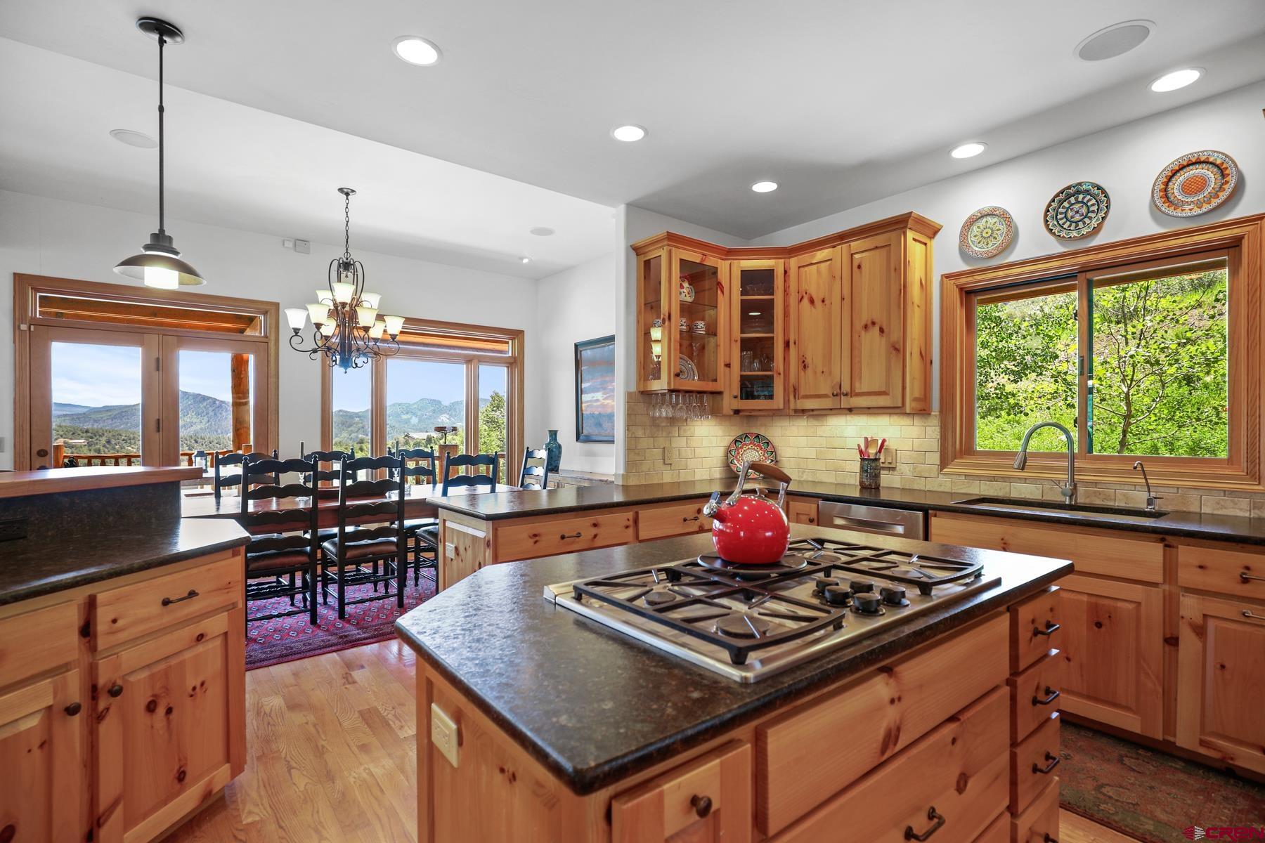 756 Horse Gulch Loop Durango, CO 81301 - Photo 9 of 35 a kitchen with stove and chairs