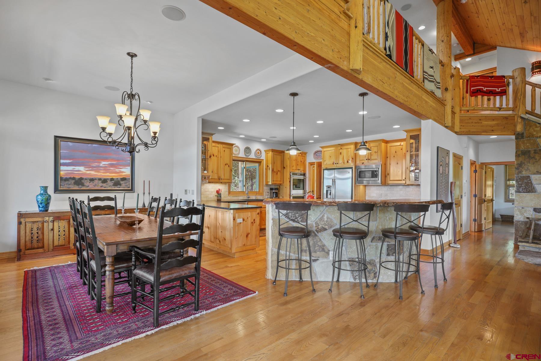 756 Horse Gulch Loop Durango, CO 81301 - Photo 10 of 35 a dining room with furniture a chandelier and wooden floor