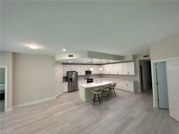 a open kitchen with a table and chairs