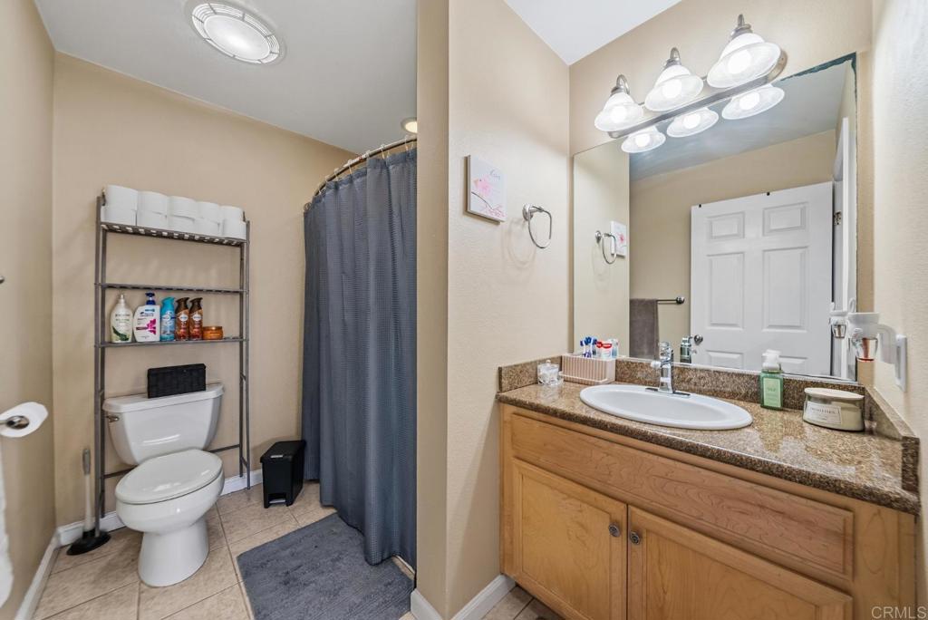 12750 Laurel Street, Unit 510 Lakeside, CA 92040 - Photo 14 of 19 a bathroom with a sink a toilet and a mirror