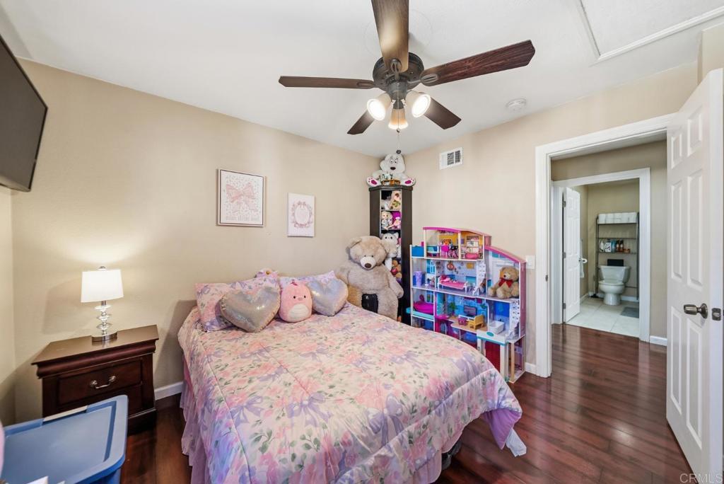 12750 Laurel Street, Unit 510 Lakeside, CA 92040 - Photo 19 of 19 a bedroom with bed and a chandelier