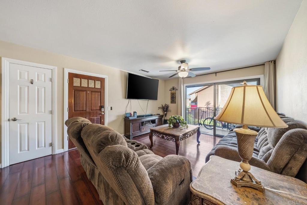 12750 Laurel Street, Unit 510 Lakeside, CA 92040 - Photo 5 of 19 a living room with furniture a flat screen tv and a large window