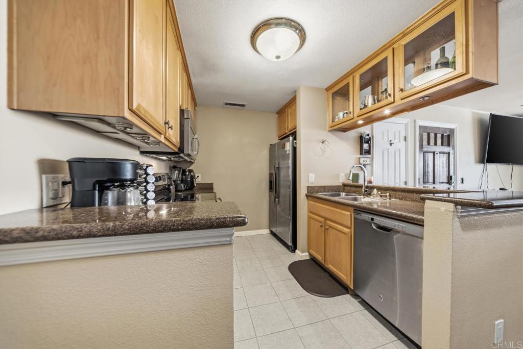12750 Laurel Street, Unit 510 Lakeside, CA 92040 - Photo 10 of 19 a kitchen with stainless steel appliances granite countertop a sink and a refrigerator