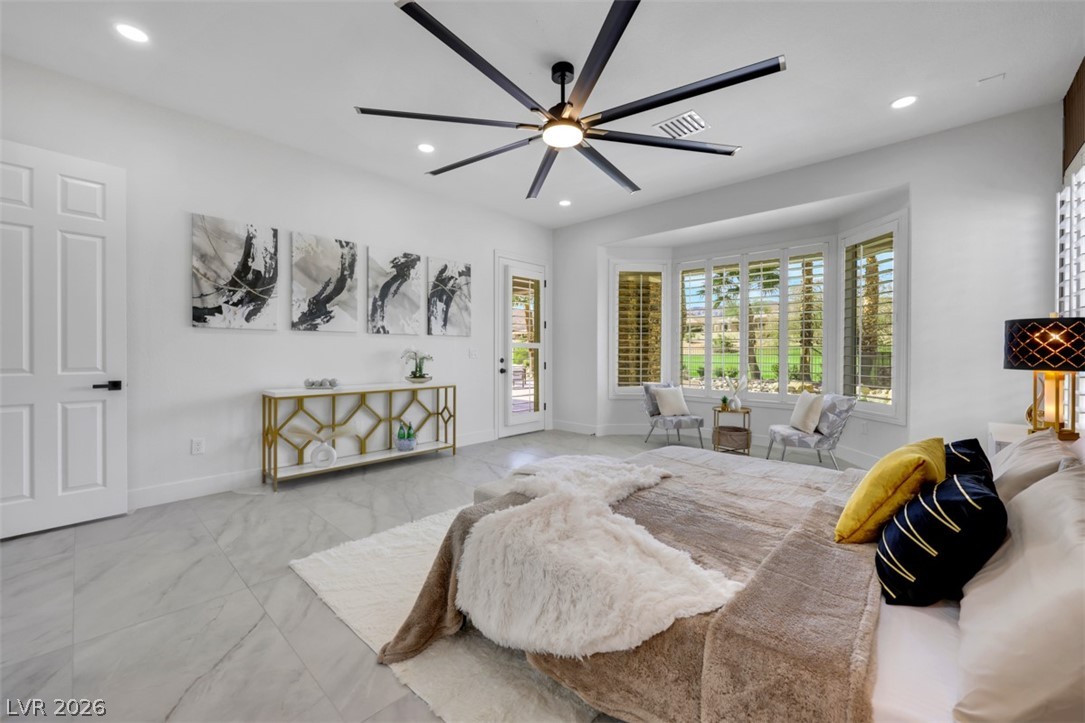 5015 Rivedro Street Las Vegas, NV 89135 - Photo 43 of 91 A spacious primary bedroom retreat with bright bay windows overlooking lush outdoor scenery.