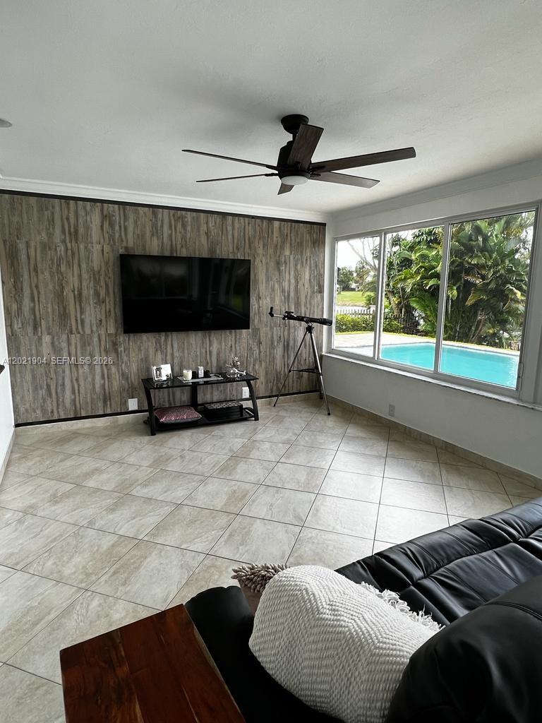 3324 Lakeview Boulevard Delray Beach, FL 33445 - Photo 9 of 36 a living room with a couch a flat screen tv and a large window