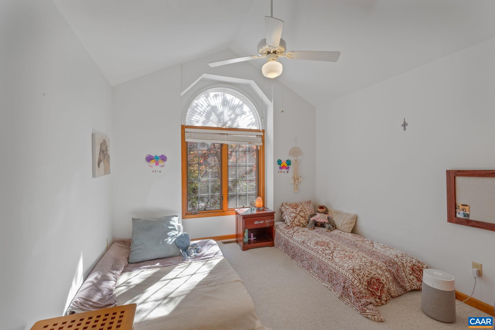 30 Brougham Road Palmyra, VA 22963 - Photo 27 of 57 a bedroom with a bed and a chandelier