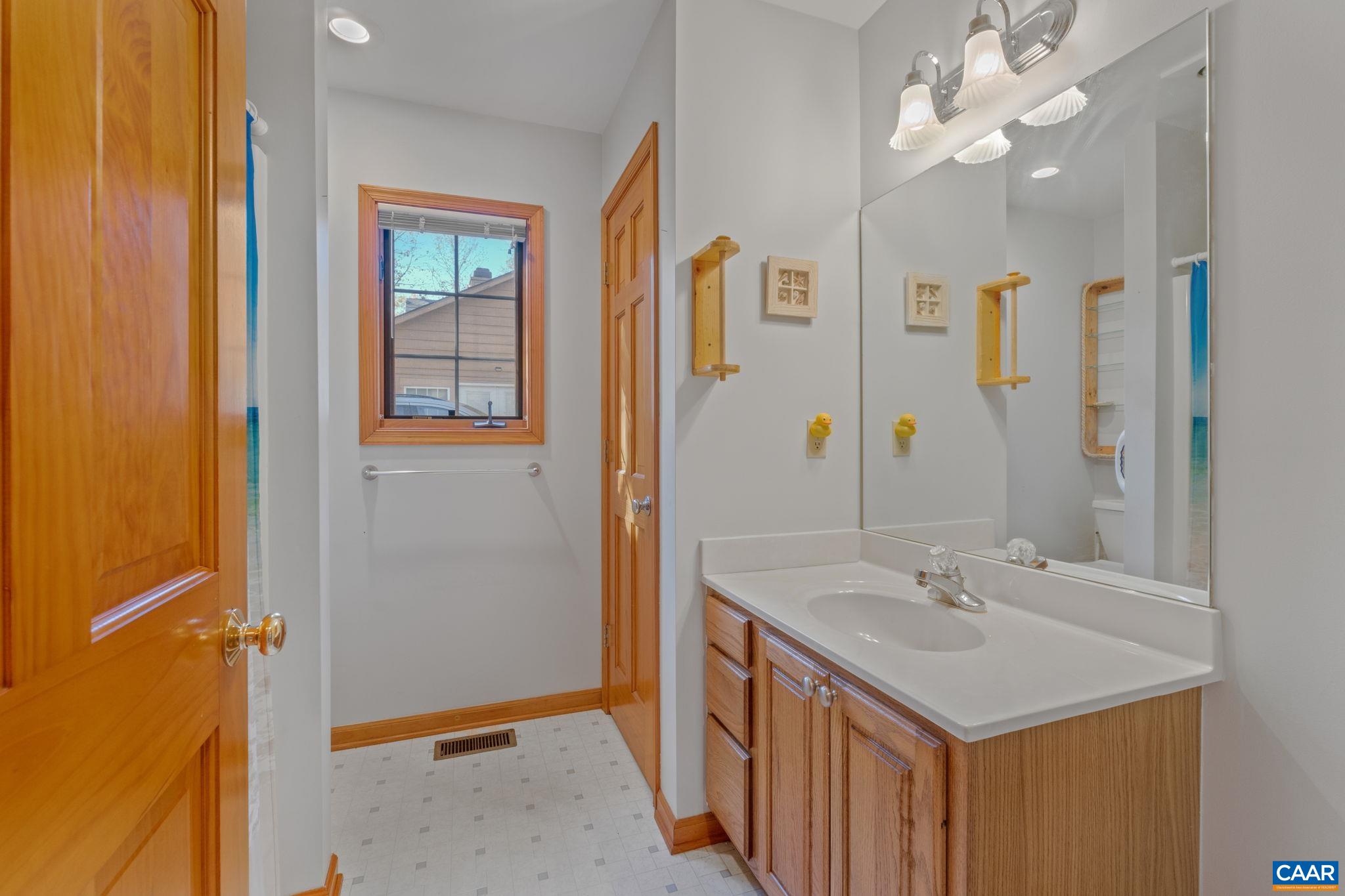 30 Brougham Road Palmyra, VA 22963 - Photo 28 of 57 a bathroom with a sink a mirror and a shower