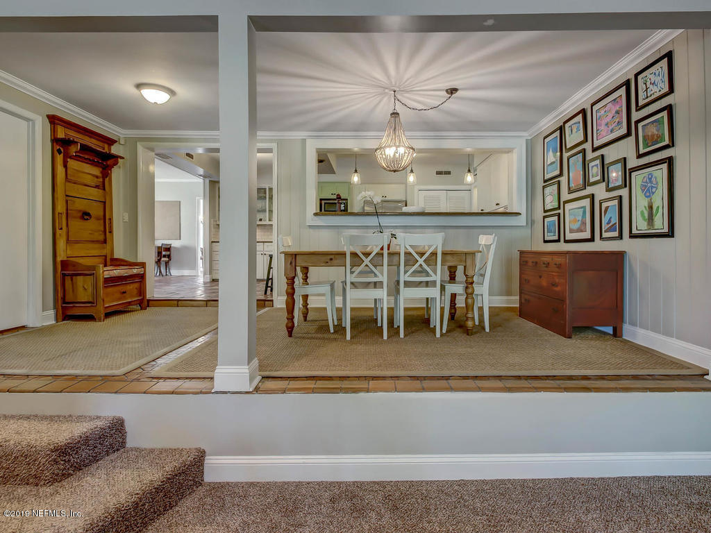 945 Mapleton Terrace Jacksonville, FL 32207 - Photo 11 of 45 a dining room with furniture and a chandelier
