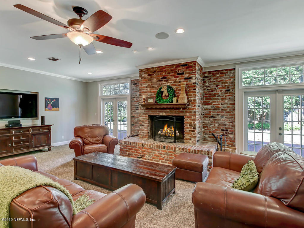 945 Mapleton Terrace Jacksonville, FL 32207 - Photo 12 of 45 a living room with furniture a flat screen tv and a fireplace