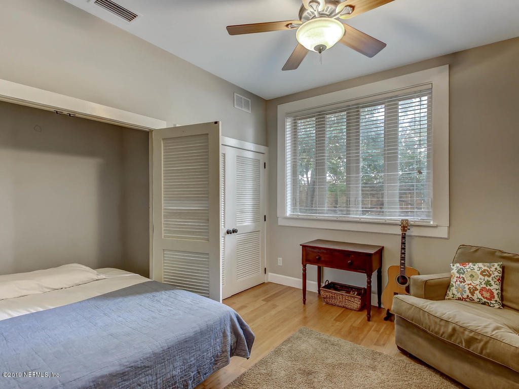 945 Mapleton Terrace Jacksonville, FL 32207 - Photo 20 of 45 a bedroom with a bed and a chandelier